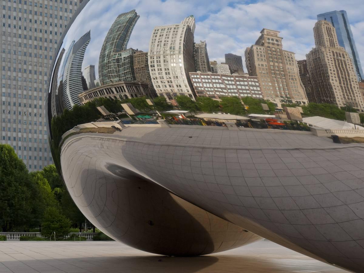 Buildings along Michigan Avenue are reflected on Cloudgate in Chicago, IL.