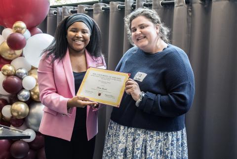 Dina Rosin receives a certificate for contributing to the Advocates' Forum 2023 issue