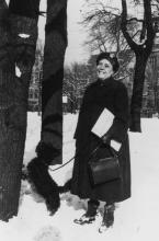 Charlotte Towle and her Scottish terrier, Paddy, standing in the snow among trees